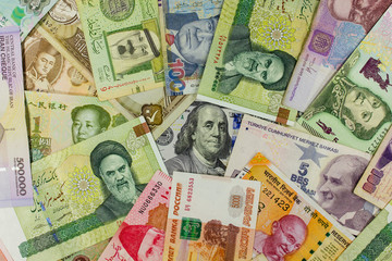 Banknotes of different countries spread around the banknote 100 US dollars. Concept of  dollar is  world currency.