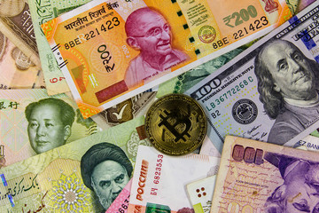 Bitcoin against  background of banknotes of different countries.