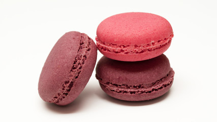 Pink and chocolate macaroon lie on each other. Isolated