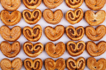 group of sugar cookies in the shape of a heart on a light background