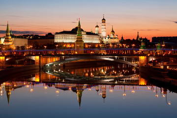 Naklejka na ściany i meble View of the Kremlin, Big stone bridge, Moscow river and their mirror image in the water at dawn, Moscow, Russia