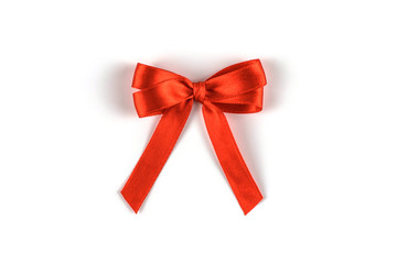 Coral silk gift bow isolated on white.