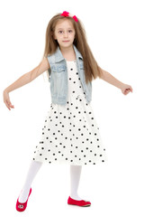 Naklejka premium A cheerful little girl is dancing.