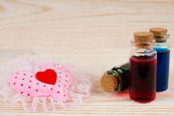 love potion. set of green, blue and red elixir and hearts.