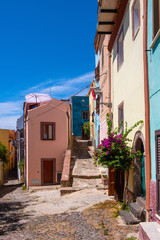 Fototapeta na wymiar Bosa, Sardinia, Italy - Bosa historic old town quarter with colorful tenements and narrow street of Via Muruidda