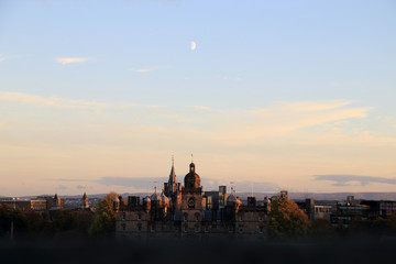 Fototapeta na wymiar Edinburgh, Scotland. Cityscape view look from Edinburgh castle in evening seeing the moon over old buildings.