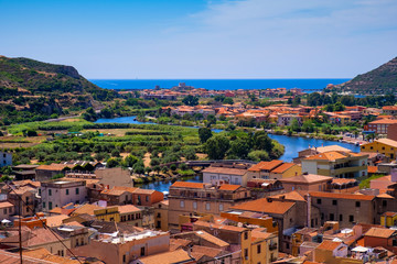 Sardinia, Italy - Panoramic view of the town of Bosa by the Temo river with Bosa Marina resort at...