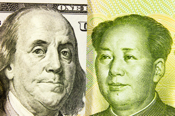 Portrait of Franklin against Mao Zedong, 100 US dollars and Chinese yuan. Concept of the economic struggle of  USD vs RMB,  US vs China, dollar vs yuan.