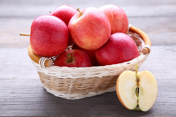 Fresh red apples on wooden background. Fresh red apples in a basket