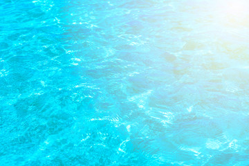 Surface of blue clear swimming pool. Water background pattern for background with sunlight