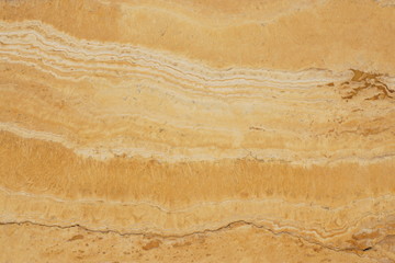 Natural stone travertine yellow color with an interesting pattern and stripes, called Travertino Giallo