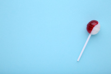 Colorful lollipop on a blue background, sweet candy concept