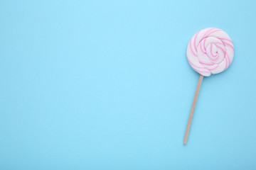 Colorful lollipop on a blue background, sweet candy concept