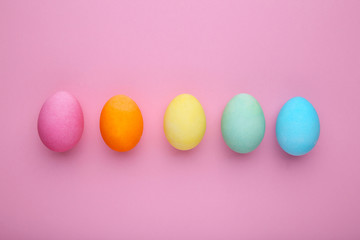 Colorful easter eggs on a pink background