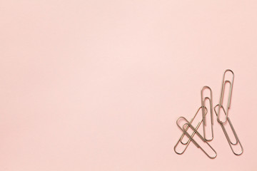 metal paper clips and paper on paper background