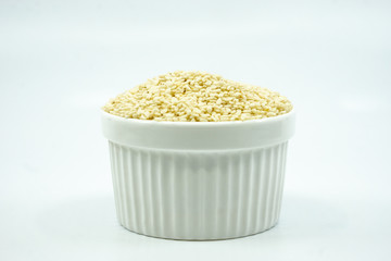 White sesame seed in white ramekin isolated on white background.