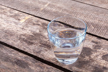 Glass of water on a wooden table