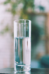 Glasses of water on a wooden table.
