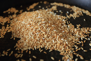 Cooking ground roasted rice or original Thai Esan roasted rice on pan. Selective focus.