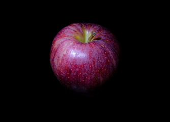 red apple on black background reflection