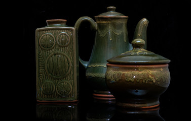 set of pottery on black background