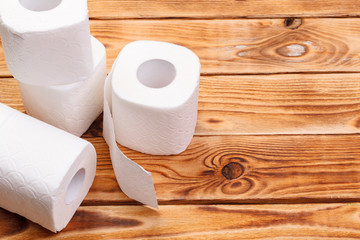 Toilet paper rolls on wooden background top view