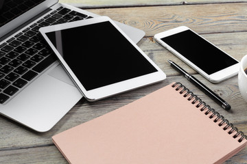 Open laptop with digital tablet and smartphone close up