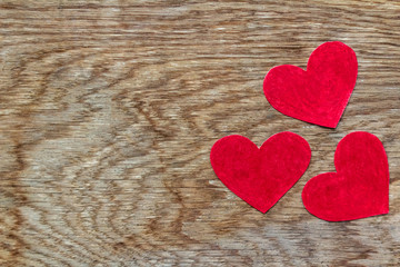 Valentines day three red hearts on wood with copy space