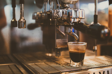 Close up of espresso pouring from coffee machine.