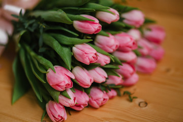 Bright pink flowers on wooden background. Colorful bouquet for Mothers Day, Birthday, International Women's Day March 8