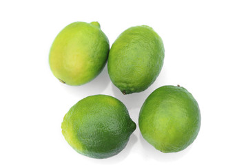Fresh green limes, tropical fruits on white background.