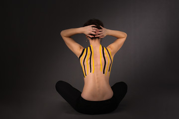 Obraz premium Medical taping. slim woman girl with dark hair