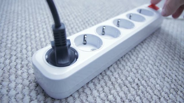 Man hands turn off and unplug wires from electricity switch at home. Energy saving concept.