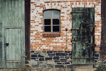 old window and door in brick wall