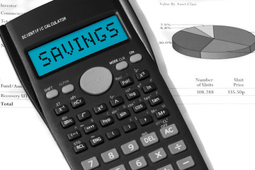 Savings on a calculator display on investment funds paperwork with selective colour