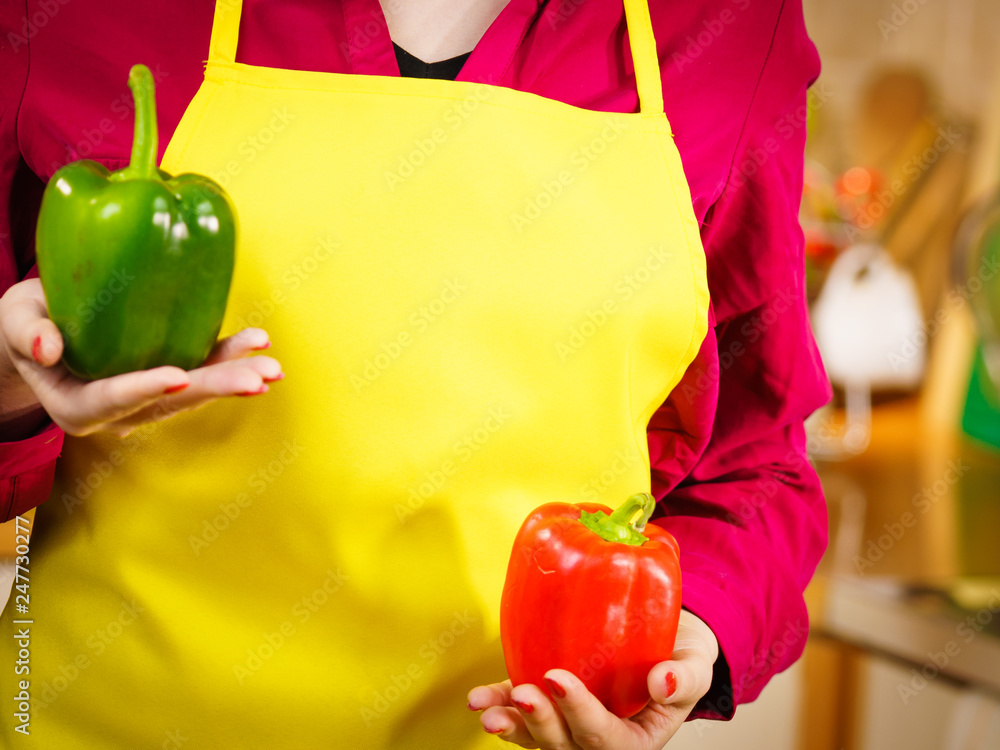 Wall mural woman holding bell peppers paprika