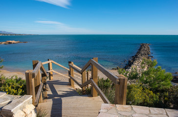 Fototapeta na wymiar Access stairs to a sea blister beach, costa daurada