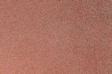 Fototapeta premium Red rubber covering for sports and playgrounds.