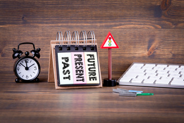 Future, present, past concept. Notebook and computer keyboard on dark wood background, table