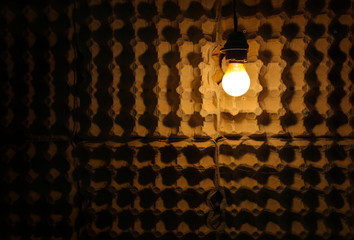 Loft design with a bulb lightning. Cardboard paper natural background texture. Interior decision.