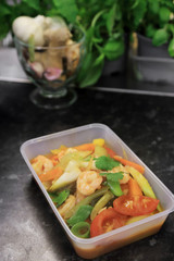 Shrimp sweet and sour stir fried with vegetable in plastic box, take away asian food.