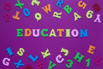 Abstract closeup of inscription education purple background for decoration design. Black background. inscription education on a purple background with multicolored letters. 