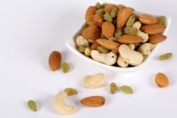 ssorted nuts on white, dry fruits, mix nuts, almond, cashew,  raisin