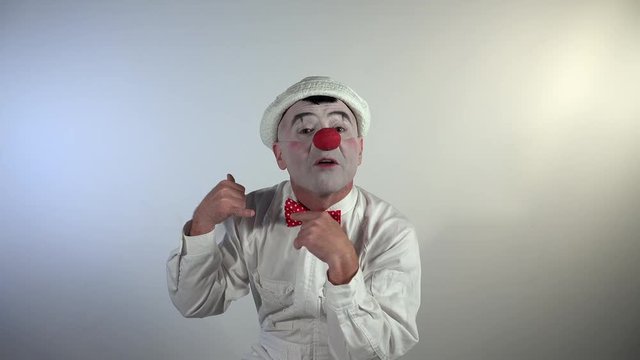Emoji Clown. A sympathetic mime clown is talking over the phone and asks another person to wait for him to finish the conversation.