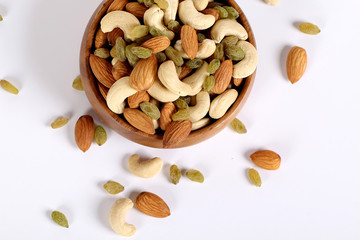 ssorted nuts on white, dry fruits, mix nuts, almond, cashew,  raisin