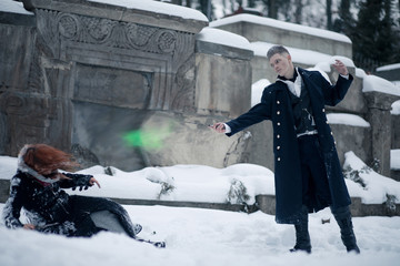 Battle of dark and light magicians with the help of magic wands and green beam.