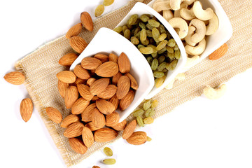 ssorted nuts on white, dry fruits, mix nuts, almond, cashew,  raisin