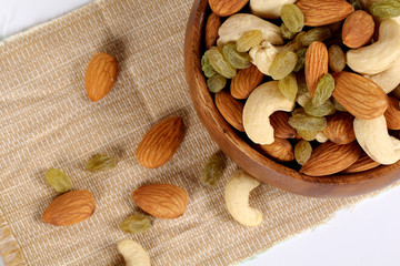 ssorted nuts on white, dry fruits, mix nuts, almond, cashew,  raisin