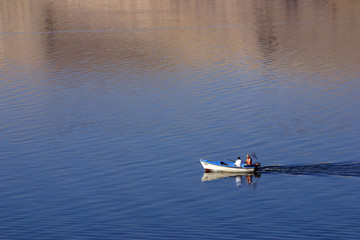 Fisherman in boat sailing out