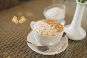 A cup of cappuccino on the table at the restaurant